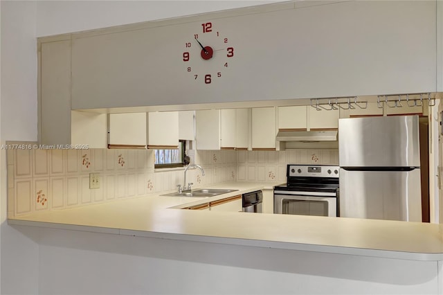 1645 SW 10th St, Miami, FL 33135 - kitchen with appliances with stainless steel finishes, under cabinet range hood, light countertops, and backsplash
