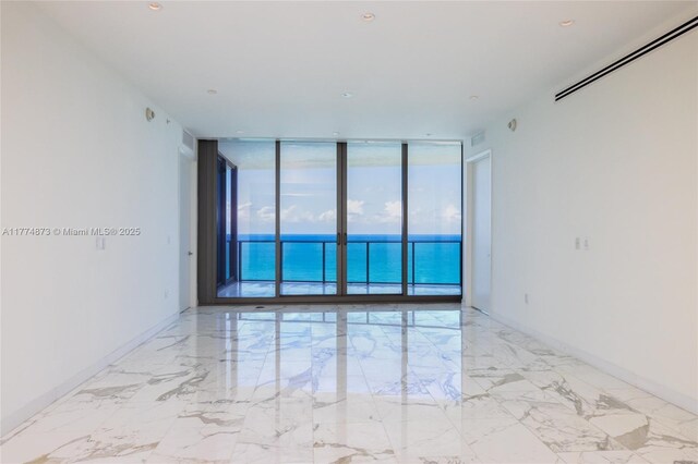 15701 Collins Ave Unit 1004, Sunny Isles Beach, FL 33160 - unfurnished room featuring a wall of windows, a water view, and marble tiled floors