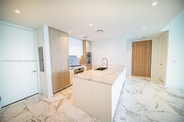 15701 Collins Ave Unit 1004, Sunny Isles Beach, FL 33160 - kitchen with modern cabinets, a sink, light stone countertops, electric panel, and recessed lighting