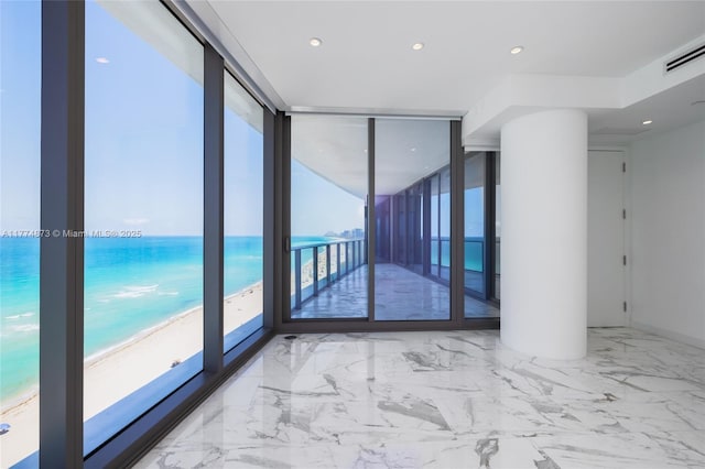 15701 Collins Ave Unit 1004, Sunny Isles Beach, FL 33160 - spare room featuring floor to ceiling windows, marble finish flooring, recessed lighting, and a water view
