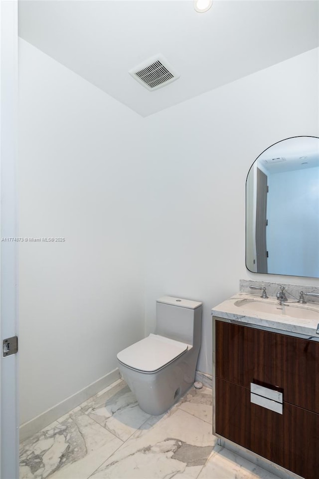 15701 Collins Ave Unit 1004, Sunny Isles Beach, FL 33160 - bathroom featuring marble finish flooring, toilet, vanity, and baseboards