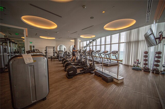 15701 Collins Ave Unit 1004, Sunny Isles Beach, FL 33160 - exercise room with expansive windows and wood finished floors