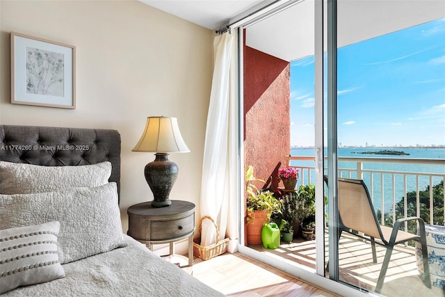 interior space featuring a wealth of natural light, wood finished floors, and a water view