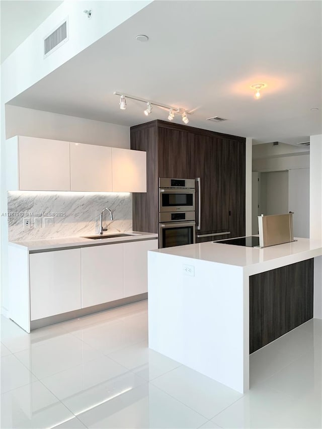 851 NE 1st Ave Unit 3905, Miami, FL 33132 - kitchen with double oven, visible vents, modern cabinets, and a sink