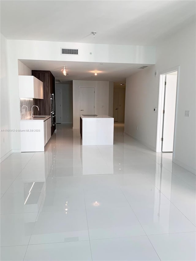 851 NE 1st Ave Unit 3905, Miami, FL 33132 - unfurnished living room featuring a sink, visible vents, baseboards, and light tile patterned floors
