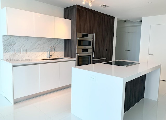 851 NE 1st Ave Unit 3905, Miami, FL 33132 - kitchen with a sink, light countertops, decorative backsplash, and black electric cooktop