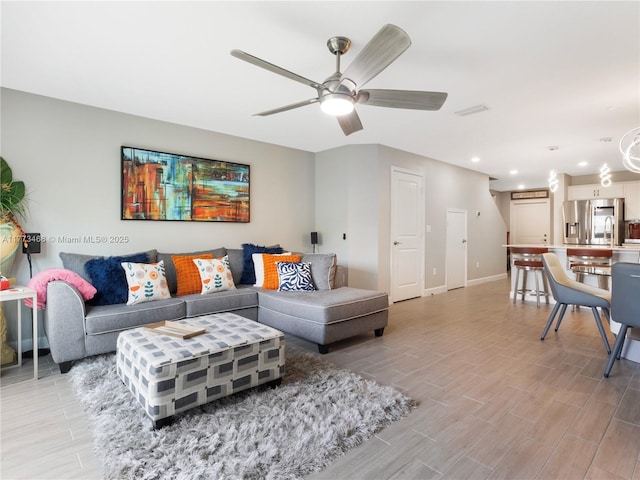 living room featuring a ceiling fan, recessed lighting, baseboards, and wood tiled floor