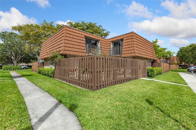 4161 Forest Hill Dr Unit 4161, Cooper City, FL 33026 - view of home's exterior featuring mansard roof and a balcony