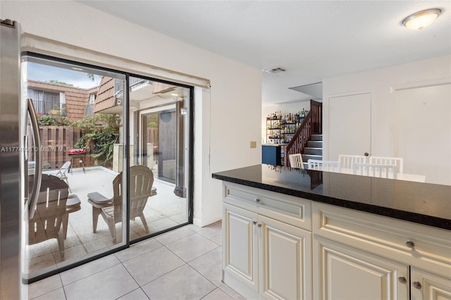 kitchen featuring visible vents, freestanding refrigerator, and light tile patterned floors