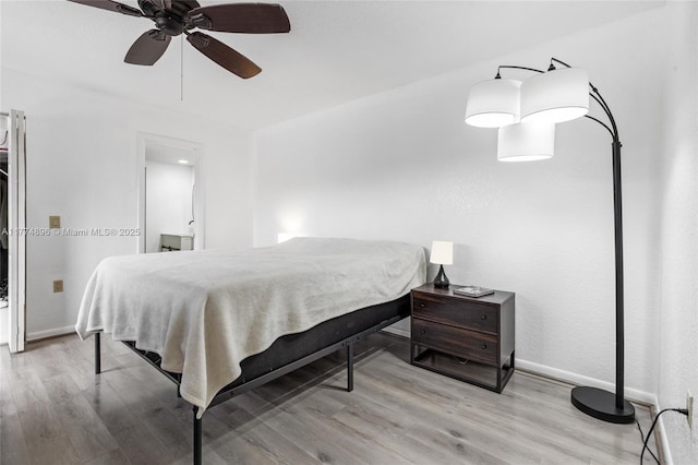 bedroom with baseboards, a ceiling fan, and wood finished floors