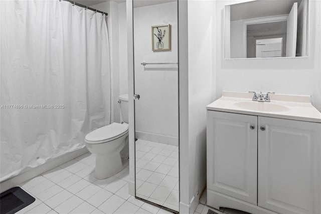bathroom with toilet, tile patterned flooring, and vanity