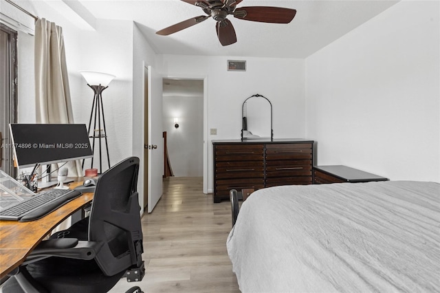 bedroom featuring visible vents, ceiling fan, and light wood-style floors
