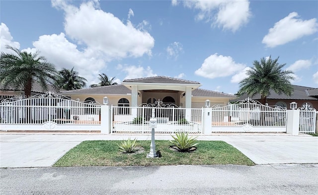14261 SW 30th St, Miami, FL 33175 - view of front of house featuring driveway, a fenced front yard, and stucco siding