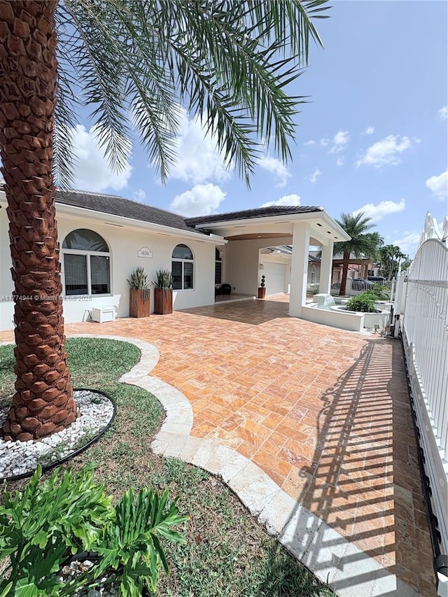 14261 SW 30th St, Miami, FL 33175 - rear view of property with stucco siding and a patio area