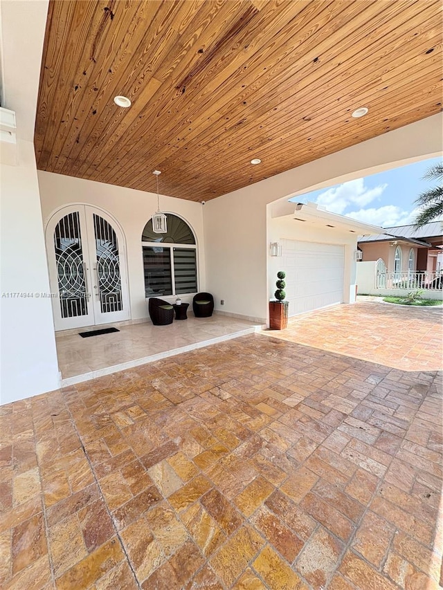 14261 SW 30th St, Miami, FL 33175 - view of patio / terrace with french doors, driveway, and an attached garage