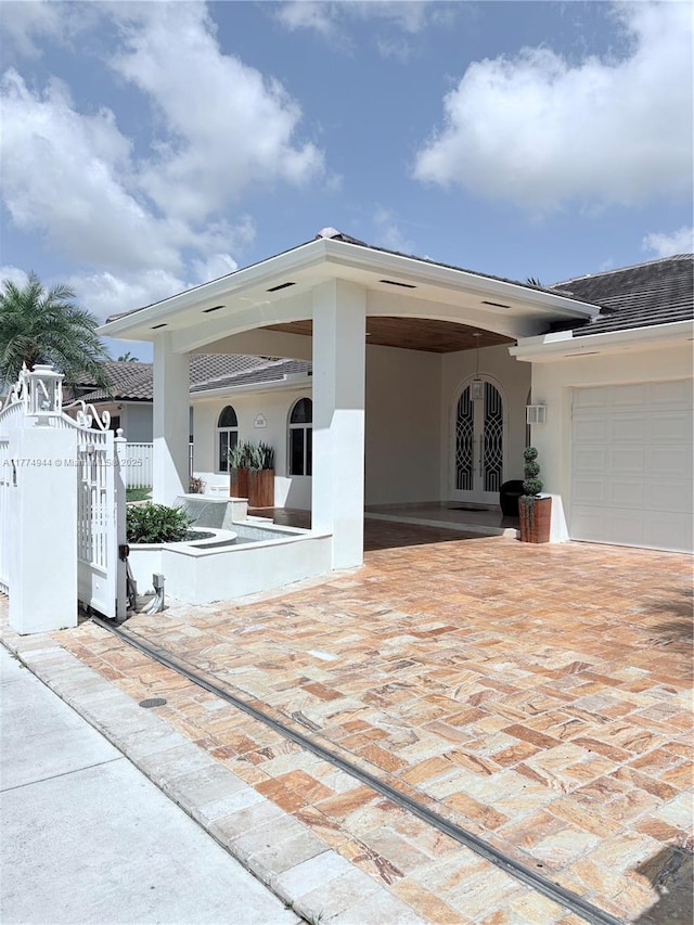 14261 SW 30th St, Miami, FL 33175 - view of patio / terrace with french doors and a garage