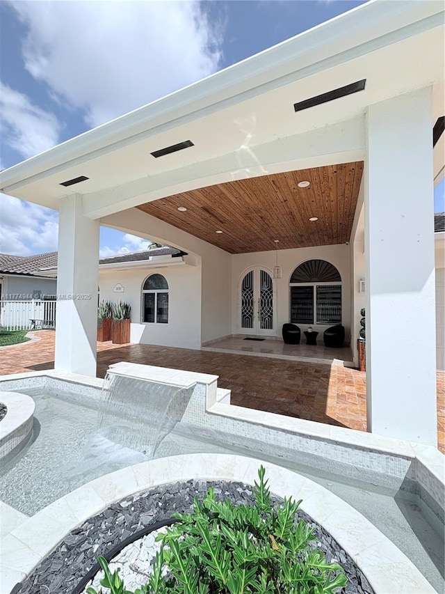 14261 SW 30th St, Miami, FL 33175 - view of patio featuring french doors