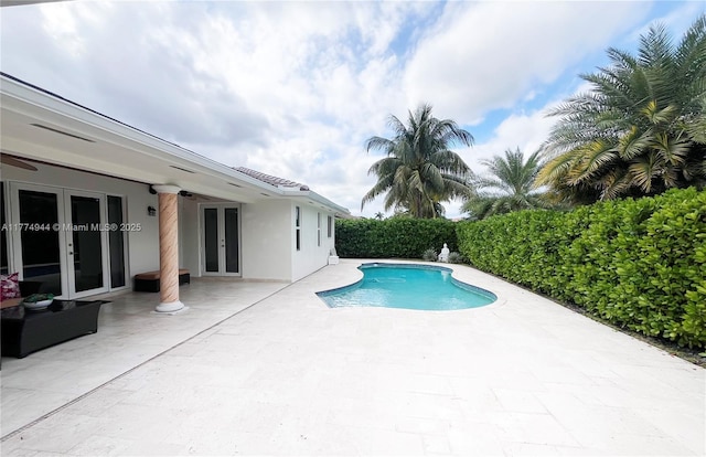14261 SW 30th St, Miami, FL 33175 - view of swimming pool featuring french doors and a patio