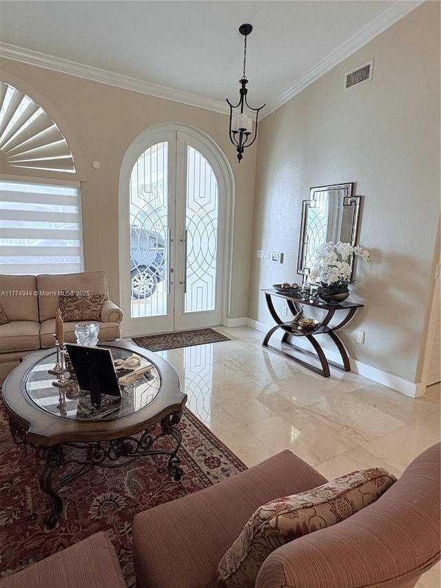 14261 SW 30th St, Miami, FL 33175 - living room featuring baseboards, french doors, crown molding, light marble finish flooring, and arched walkways