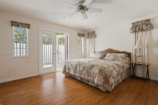 bedroom featuring access to outside, baseboards, ceiling fan, and wood finished floors