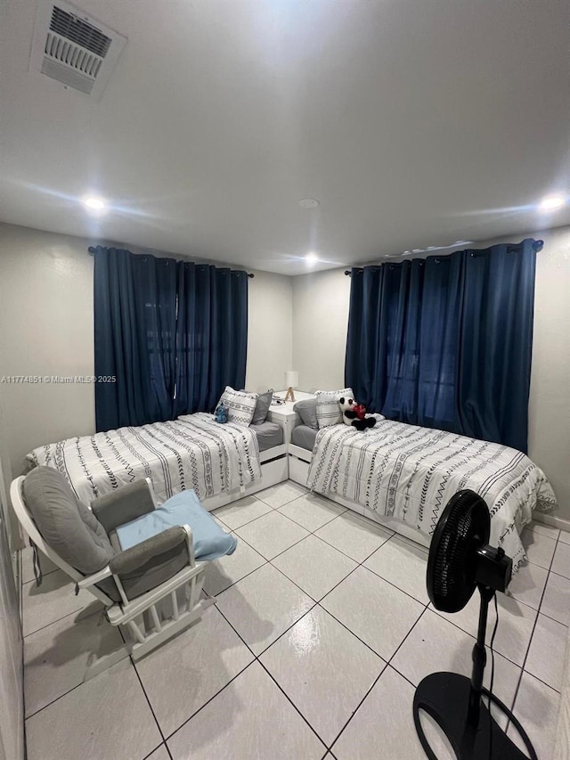 bedroom with light tile patterned floors and visible vents