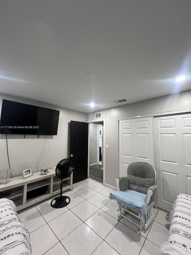 living area with light tile patterned flooring and visible vents