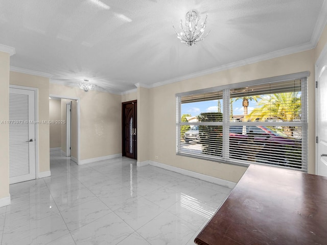 unfurnished room featuring an inviting chandelier, marble finish floor, ornamental molding, and baseboards