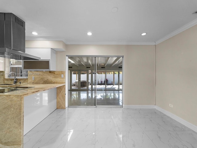 kitchen with white cabinetry, marble finish floor, baseboards, decorative backsplash, and ornamental molding