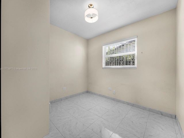 spare room featuring baseboards