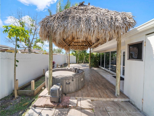 view of patio featuring a fenced backyard and a hot tub
