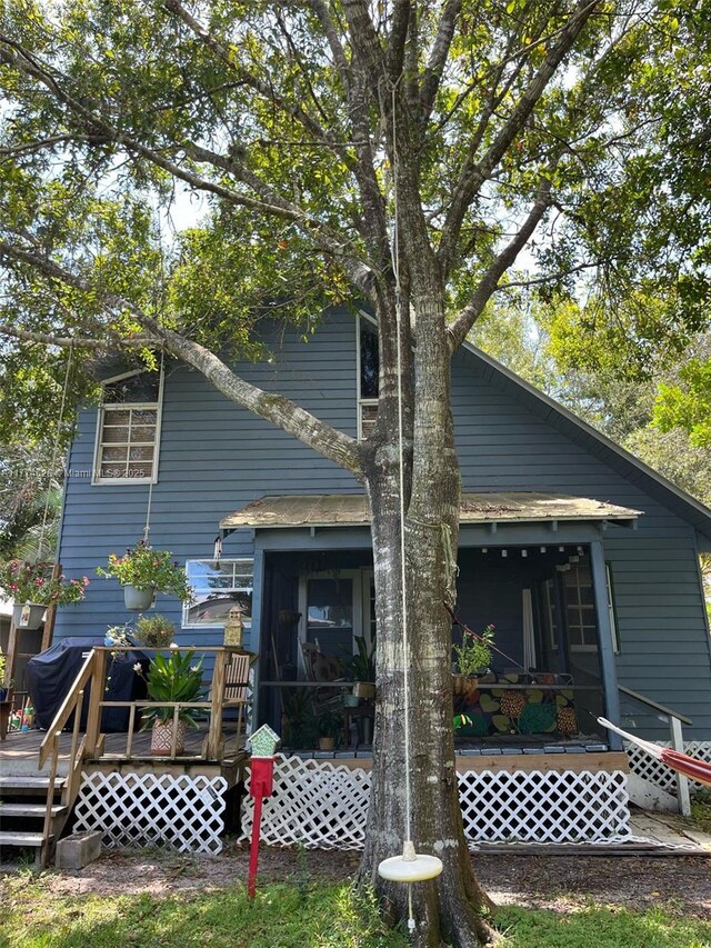 5508 Spruce Dr, Fort Pierce, FL 34982 - back of house featuring a sunroom and a deck