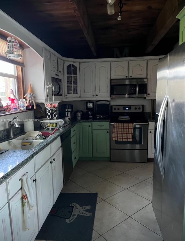 5508 Spruce Dr, Fort Pierce, FL 34982 - kitchen with light tile patterned flooring, white cabinets, a sink, and appliances with stainless steel finishes