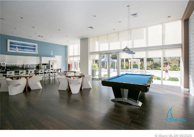 game room featuring a wall of windows, visible vents, and wood finished floors