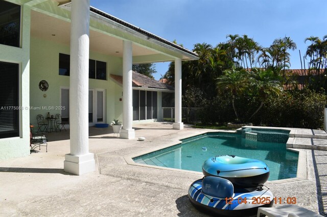 12044 NW 9th Pl, Coral Springs, FL 33071 - view of pool featuring a patio area, a pool with connected hot tub, and fence