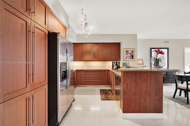 kitchen with light stone countertops, stainless steel fridge, a peninsula, dishwashing machine, and visible vents