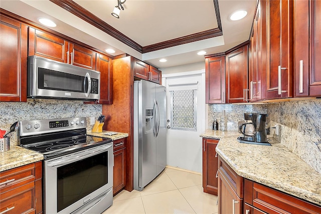 2940 N Course Dr Unit 712, Pompano Beach, FL 33069 - kitchen with appliances with stainless steel finishes, reddish brown cabinets, crown molding, light stone counters, and tasteful backsplash