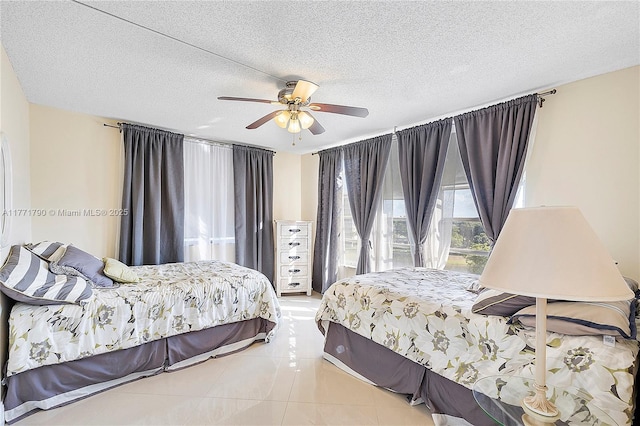 2940 N Course Dr Unit 712, Pompano Beach, FL 33069 - bedroom featuring light tile patterned flooring, a textured ceiling, and a ceiling fan
