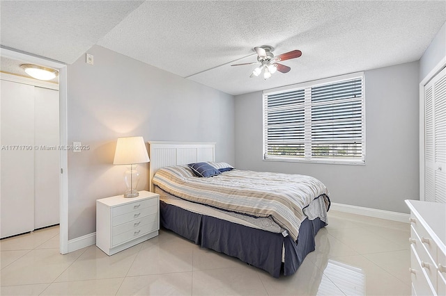 2940 N Course Dr Unit 712, Pompano Beach, FL 33069 - bedroom with baseboards, light tile patterned floors, a textured ceiling, and ceiling fan