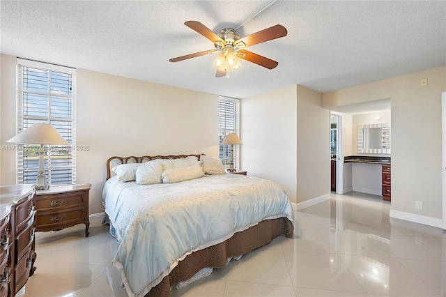 2940 N Course Dr Unit 712, Pompano Beach, FL 33069 - bedroom with light tile patterned floors, baseboards, a textured ceiling, and a ceiling fan