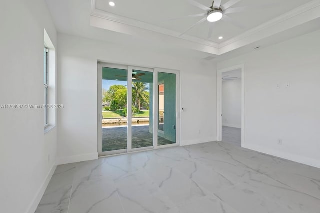 unfurnished room with a ceiling fan, a raised ceiling, and baseboards
