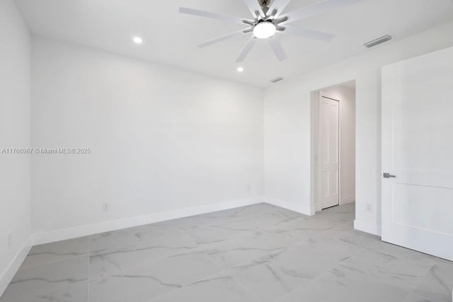 unfurnished room with marble finish floor, baseboards, and visible vents