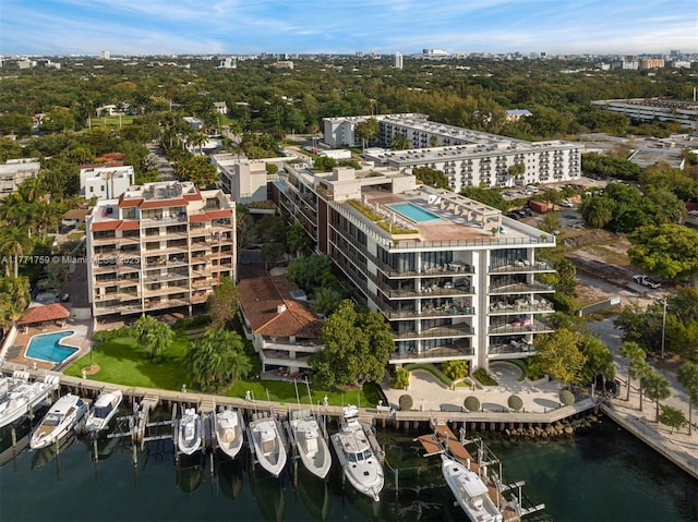 view of urban area featuring a large body of water and a pool area