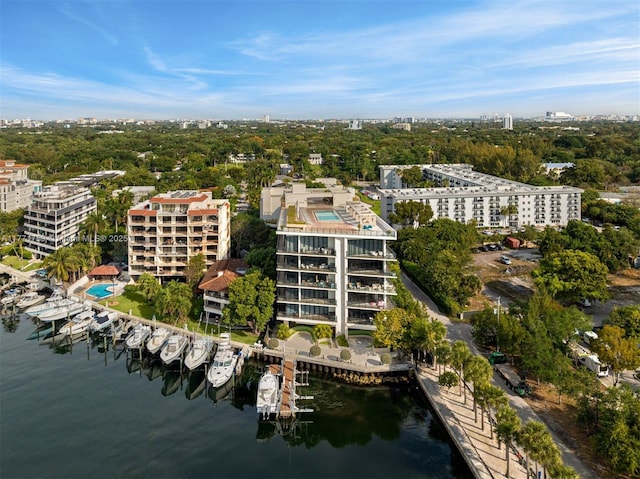 aerial view of property's location featuring a nearby body of water, nearby urban area, and apartment complex / building
