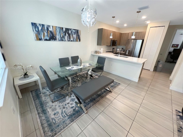 dining space with baseboards, visible vents, and light tile patterned floors