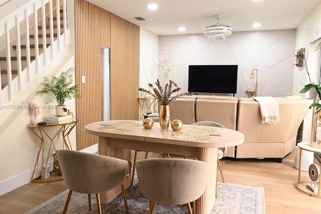 dining area featuring visible vents, stairway, light wood-style floors, and recessed lighting