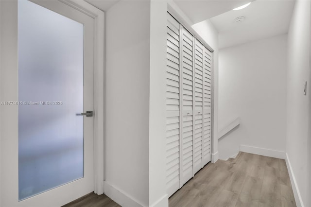 8775 Park Blvd Unit 111, Miami, FL 33172 - hall featuring baseboards, light wood finished floors, and an upstairs landing