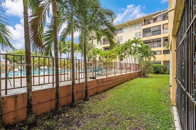8775 Park Blvd Unit 111, Miami, FL 33172 - view of yard featuring fence and a community pool