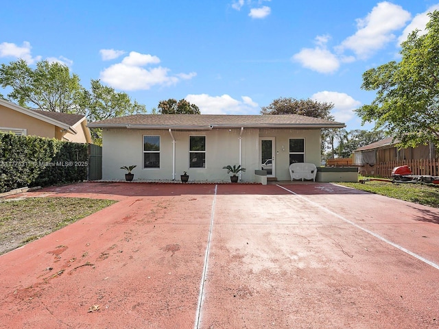 view of front of property with stucco siding and fence