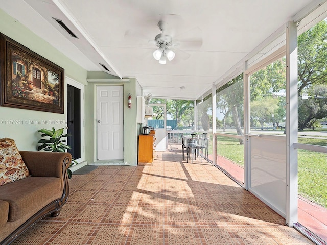 sunroom with visible vents and ceiling fan