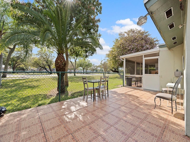 view of patio / terrace with a sunroom and fence